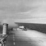 US Navy WWII plane landing on an aircraft carrier