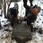 Volunteers raising Robert Emmet Winslow's headstone at Mount Moriah Cemetery